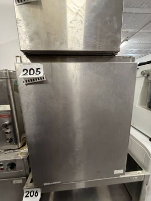 a stainless steel oven sitting in the middle of a kitchen