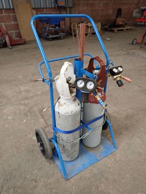 a blue cart with two propane gas cylinders on it