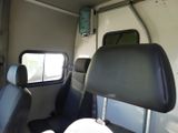 two seats in the back of a bus with a window open