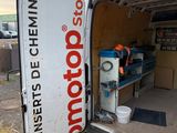 a white van with a red and white sign on the back