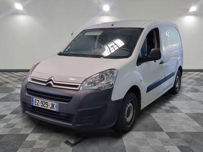 a white van parked in a room with checkered flooring