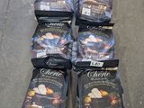 several bags of food sitting on the floor next to each other