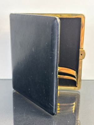 a black and gold wallet sitting on top of a table