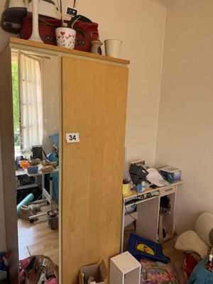 an image of a bedroom with a closet and a bed