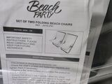 a sign on the back of a car stating that it has two folding beach chairs