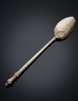 a silver spoon with a design on the handle