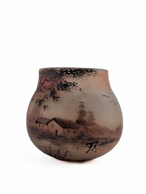 a vase with a painting on it on a white surface