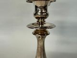 a silver candle that is sitting on a table