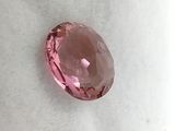 a close up of a pink diamond on a white surface
