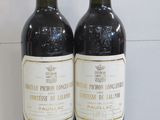 two bottles of wine sitting next to each other on a table