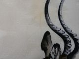 painting of a giraffe with large horns on a white wall