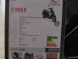 a sign on the floor advertising the price of a motorcycle