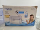 packaging of a water purifier sitting on a table next to a box of water