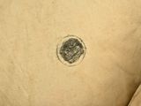 a black and white drawing of a circle on a piece of cloth