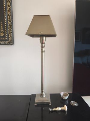 a lamp that is sitting on a table next to a mirror