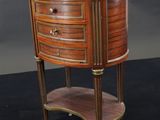 a small wooden table with a marble top on a black surface