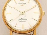 an image of a gold wrist watch with a brown leather strap