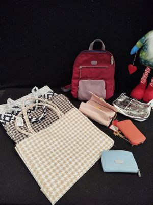 a bag, purse, wallet, cell phone and other items on a table