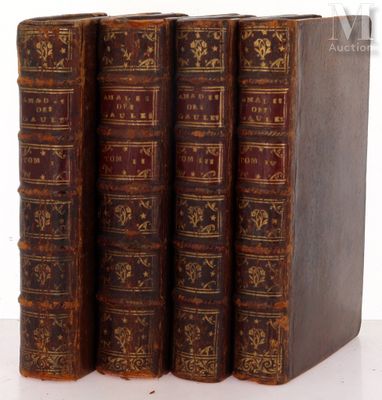 three old books sitting on top of each other on a table