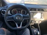 dashboard of a car with a person sitting in the driver ' s seat