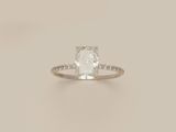 an engagement ring with a cushion cut diamond surrounded by diamonds