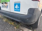 a white van with stickers on it parked on the side of the road