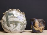 two vases sitting next to each other on a table