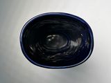a blue bowl sitting on top of a white table
