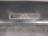 a black purse with a metal handle on a table