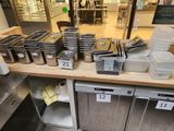 many trays of food sitting on a counter in a store