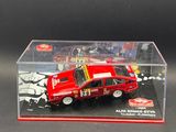 display case with a red car in it on a black surface
