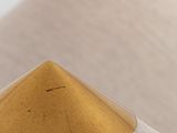 three wooden pyramids sitting on top of a beige fabric covered surface