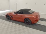 an image of an orange sports car in a garage