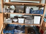 a kitchen with a wooden shelving with many items on it