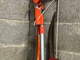 a bike that is leaning against a wall with a red handle