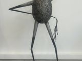an image of a sculpture of a bird on a wooden floor