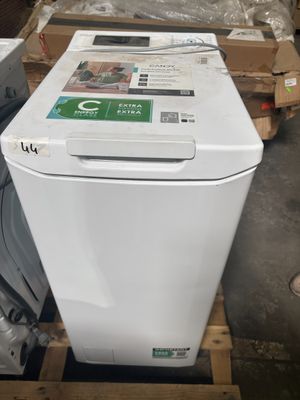 an image of a white dishwasher sitting on top of a wooden pallet
