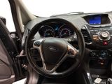 the interior of a car with a steering wheel and dashboard controls