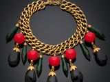 a close up of a necklace on a black background