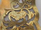 an image of a gold plate with a flower design on it