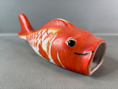 a small red fish that is sitting on a table