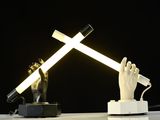 a lamp that is on a table with a hand