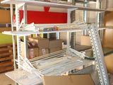 a pile of boxes and boxes on a shelf in a room