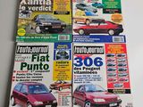 three magazines of different cars on a table with a white background