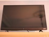 a flat screen tv sitting on top of a shelf