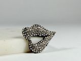 a close up of a ring on a marble block on a white surface