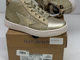 gold glittered high top sneakers with laces on top of a cardboard box