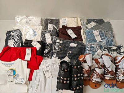 many pairs of clothes and sandals on a table