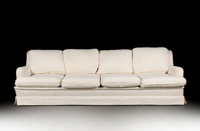 a white couch that is sitting on a white floor