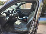 the interior of a car with the door open and the driver ' s seat down